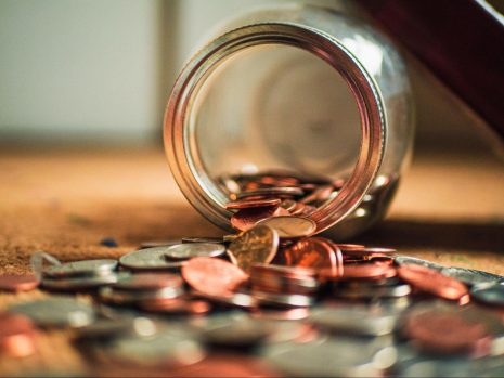 jar of coins spilled on the ground